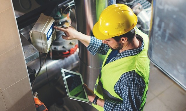 Worker checking work orders on tablet